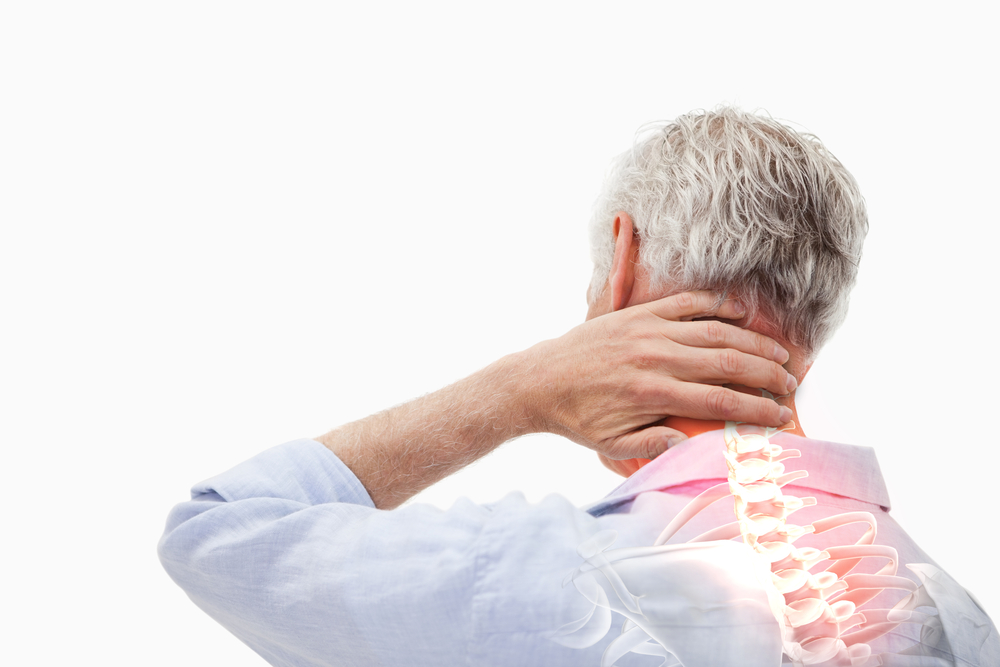 A man rubbing his neck after feeling some types of chronic pain.